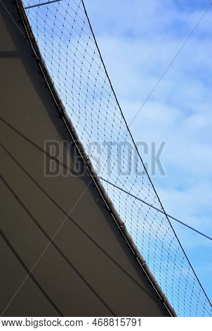 White Tarpaulin Taut, Shading From The Sun And Rain Over The Terrace Of The Restaurant, On The Playg