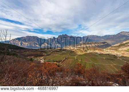 Aerial View Of Lake Garda With The Alps And The Small Village Of Nago-torbole, View From The Mountai