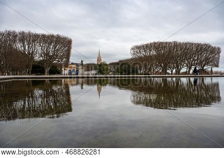 Montpellier, Occitanie, France, 12 28 2022 - Reflections Of Trees And Historical Buildings At The Pe