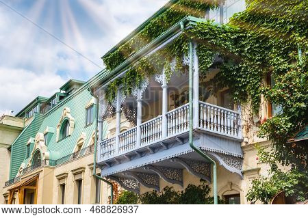 Carved Wooden Balcony And Colorful Buildings In Historical Tbilisi, Georgia. Traditional Decoration 