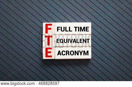 Text Fte Full Time Equivalent Writing On Notebook With Hand Holding Pencil,clock,calculator And Glas