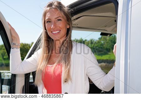 Beautiful Woman With Campervan During Motorhome Road Trip In Vanlife