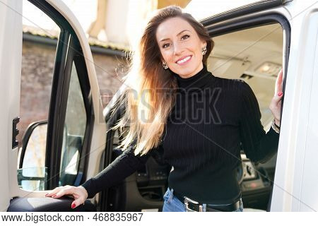 Beautiful Smiling Woman Driving Motor Rv Campervan Home Van In Vanlife Style Concept