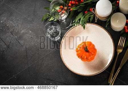 Autumn Table Setting With Plate, Cutlery, Pumpkin And Candles. Thanksgiving Food Festive Dinner Conc