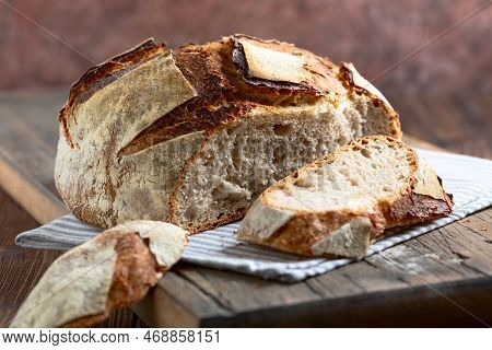 Traditional Freshly Baked Rustic Bread With Cut Slices On A Linen Cloth, Selective Focus. Artisan So
