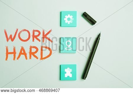 Hand Writing Sign Work Hard. Word For Laboring That Puts Effort Into Doing And Completing Tasks