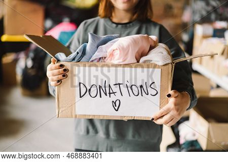 Volunteer Teengirl Preparing Donation Boxes For People. Donation Clothing For Refugees, Support Of W