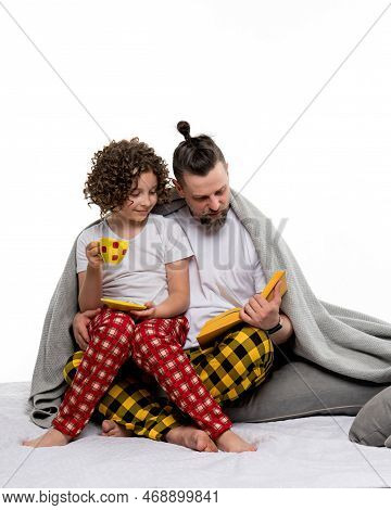Happy Family In Plaid Pajamas On White Studio Background. Curly Short-haired Daughter In Sleepwear S