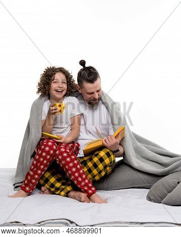 Happy Family In Plaid Pajamas On White Studio Background. Curly Short-haired Daughter In Sleepwear S
