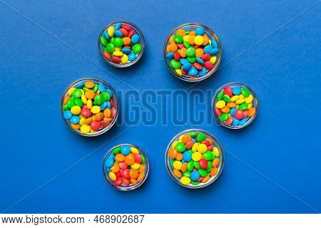 Different Colored Round Candy In Bowl And Jars. Top View Of Large Variety Sweets And Candies With Co