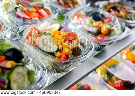 Boxes With Pre-packaged Vegetable Salads In A Commercial Fridge