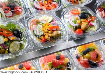 Plastic Boxes With Pre-packaged Vegetable Salads, Put Up For Sale In A Commercial Refrigerator