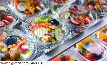 Boxes With Pre-packaged Vegetable Salads In A Commercial Fridge