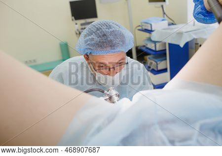 A Proctologist Examines A Rectal Colonoscopy Patient Lying On A Medical Chair In The Surgical Office