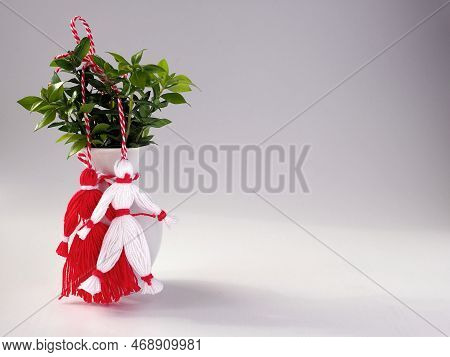 Bouquet Of Branches With Green Leaves In A Vase With Martisor Red And White Dolls On White Backgroun