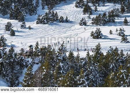 Group Of People Hiking On Fresh Snow In Mountains. Huskey Sleigh Ride. Winter Ski Holidays In Andorr