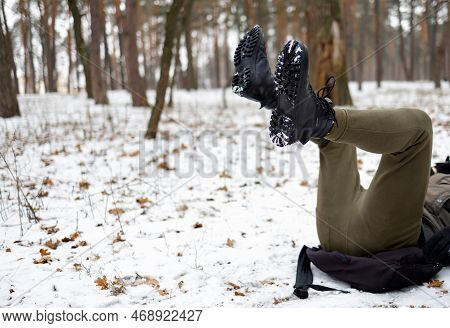 Young Man Slipped And Lost His Balance During A Walk On A Birch Grove In Winter.
