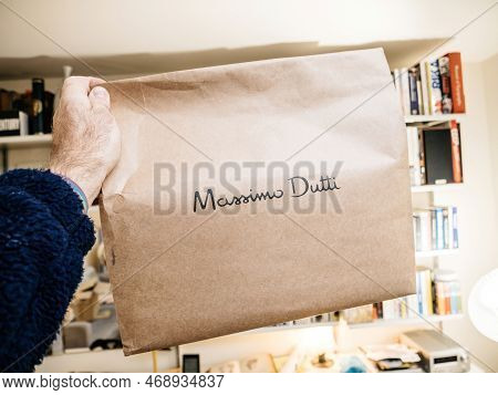 Paris, France - Dec 2, 2022: Pov Male Hand Holding Parcel Package With Massimo Dutti Fashion Retaile