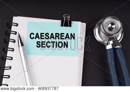 Medical Concept. On A Black Surface, A Stethoscope, A Notebook, A Pen And A Blue Sticker With The In