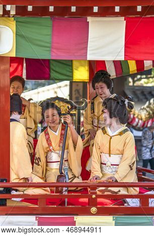 Tokyo, Japan - March 18 2020: Yatai Cart Overlooked By A Buddhist Temple's Roof In Which Sit The Mat