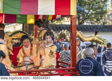 Tokyo, Japan - March 18 2020: Yatai Cart Overlooked By A Buddhist Temple's Roof In Which Sit The Mat