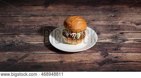 Pulled Pork Sandwish With Coleslaw On A Plate.