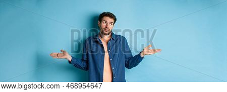Indecisive Young Man With Beard, Look Away And Shrugging Shoulders, Know Nothing, Being Clueless, St
