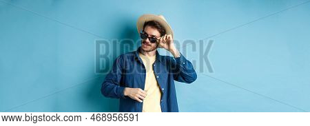 Handsome Tourist In Sunglasses And Straw Hat Looking Aside, Smiling Pleased, Exploring Sighsteeing O
