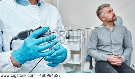 Doctor Otolaryngologist Holding Video-endoscope For Endoscopic Check-up Of Ent Organs Before Examina