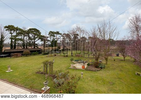 Kennett, Suffolk, England - March 1 2019: Landcaped Grounds And Gardens With Patio And Expansive Law