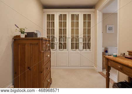 Kennett, Suffolk, England - March 1 2019: Dressing Room With Built In Glass Panelled Wardrobe And Pi