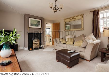 Kennett, Suffolk, England - March 1 2019: Furnished Luxury Living Room With Fireplace, Upholstered C