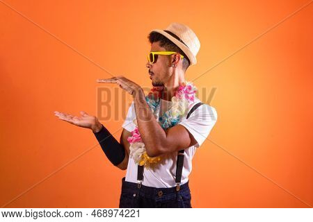 Portrait Of Black Man With Carnival Props Isolated On Orange Background.