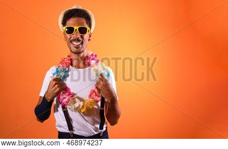 Portrait Of Black Man With Carnival Props Isolated On Orange Background.