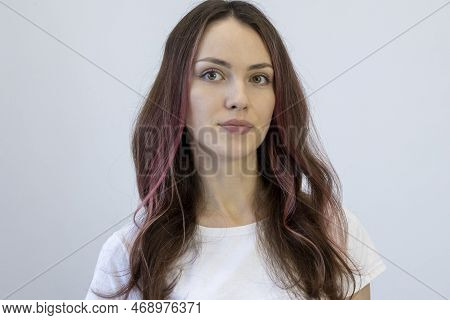 Beautiful Young Woman With Coarse Curls Of Pink Hair Looks Into The Camera.