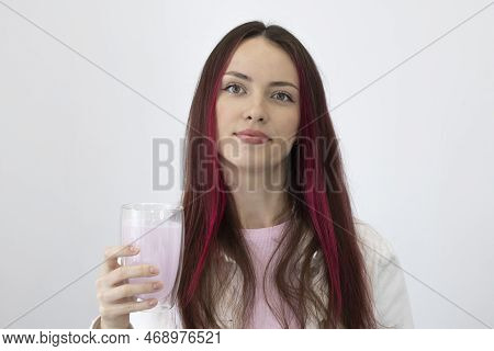 Portrait Of A Healthy Young Woman With A Pink Drink Glass In Her Hand On A White Background. Hydroly