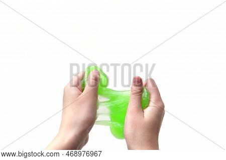 Hand Playing With Textured Slime On White Background. Teen Hand Holding Green Shining Slime With Bub