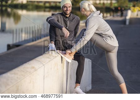 Jogging Concepts. Two Positive Caucasian Runners Athletes Relaxing During Training Together And Smil