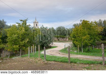 Ruins Of The Old Roman City Of Conimbriga In Portugal With A Medieval Church In The Background