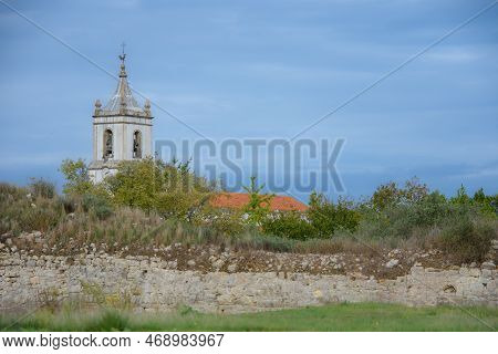 Ruins Of The Old Roman City Of Conimbriga In Portugal With A Medieval Church In The Background
