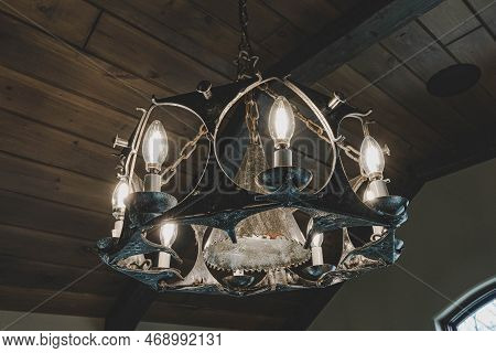 Medieval Style Chandelier Glows Bright While Hanging Over Head