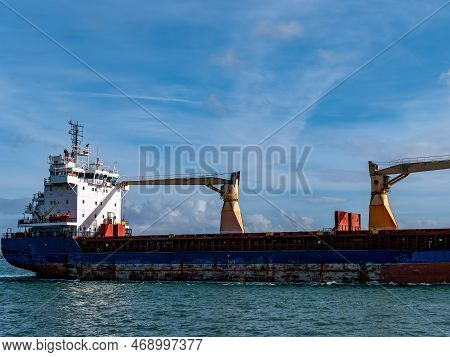 Cobh, Ireland, August 10, 2022. An Old Rusty Big Ship Is Sailing On The Sea, Sky. Cargo Ship On Sea.