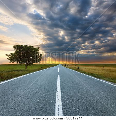 Driving On An Empty Road At Sunrise