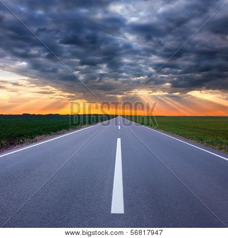 Driving On An Empty Road Towards The Storm