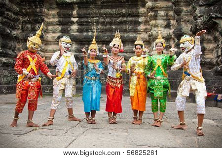 SIEM REAP,CAMBODIA-NOV 20, 2013:An unidentified cambodians in national dress poses for tourists in Angkor Wat,on Nov 20, 2013,Siem Reap,Cambodia.Angkor is the country's prime attraction for visitors.