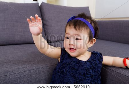 Baby girl waving hand