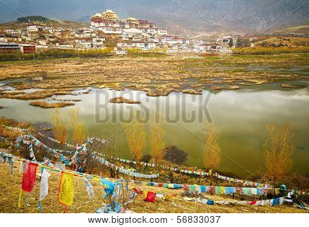 Landscape with tibetan monastery and lake
