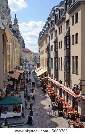 DRESDEN, GERMANY - MAY 13: People walk along Munzgasse in center of Dresden on May 1, 2009 in Dresden, Germany. Munzgasse - the street where there are many cafes and restaurants.