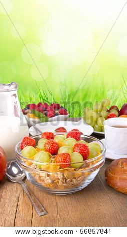 Fresh healthy food on wooden table, with green background