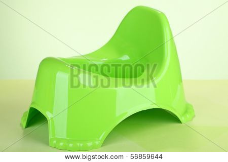 Green potty on color background